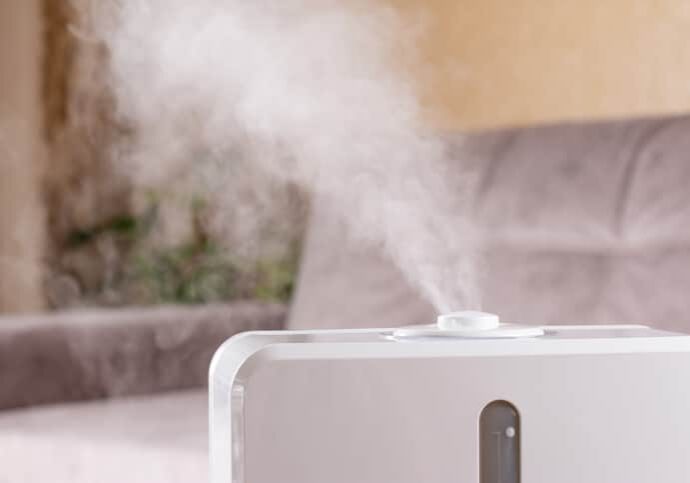 White air humidifier during work clean air and vaporizes steam up. Aromatherapy at home. Improving comfort of people.