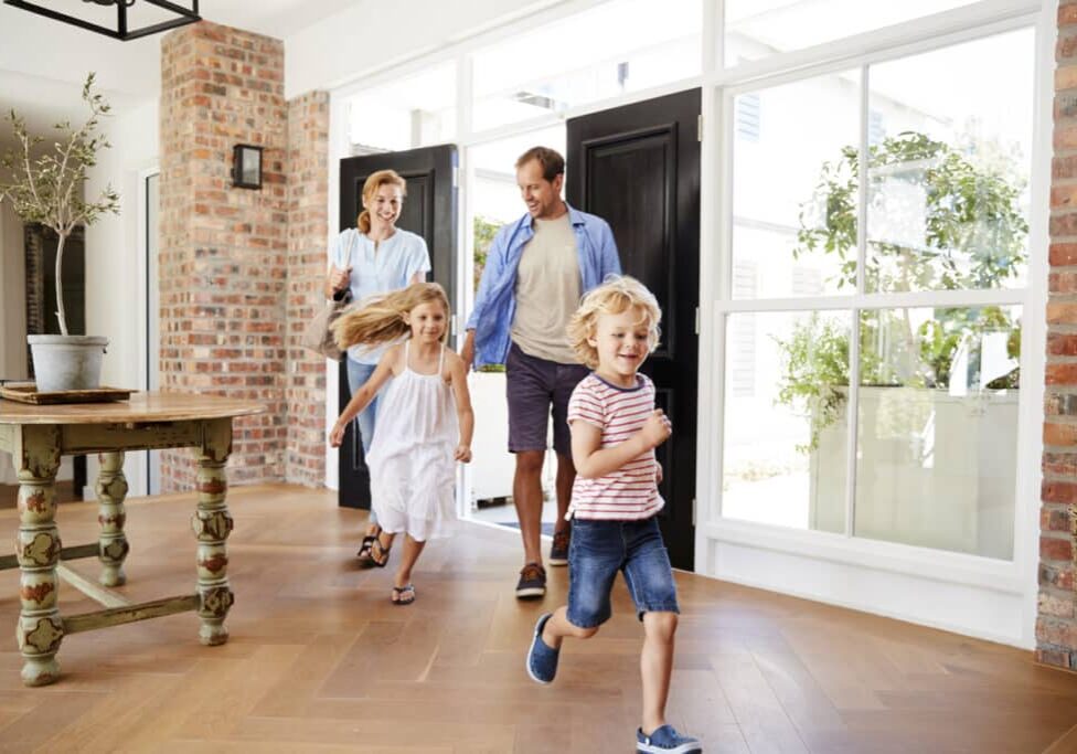 Young family arriving back to their home